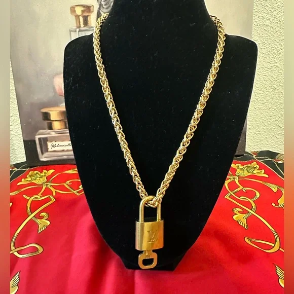 Authentic Louis Vuitton lock and key #308
with unbranded chain and earrings. - Picture 2 of 5